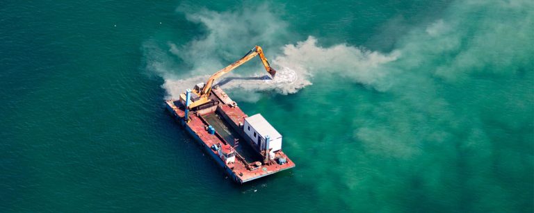 The mining machine search for minerals in the water.