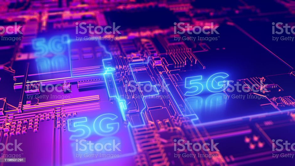 A colourful PCB board in pink and purple colours with 5G illuminated on it in blue
